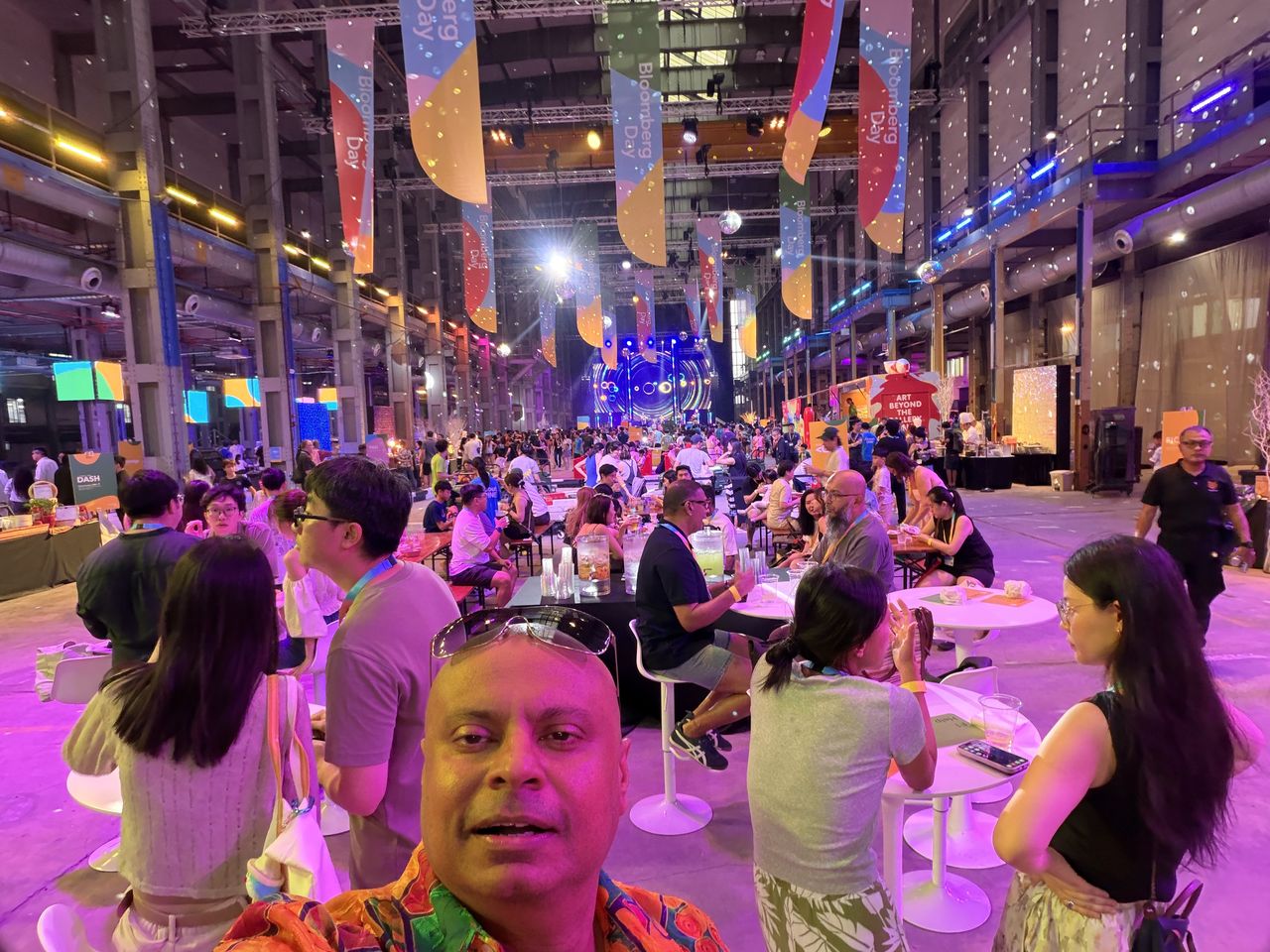 Rico Smith at a night carnival with the crowd behind him