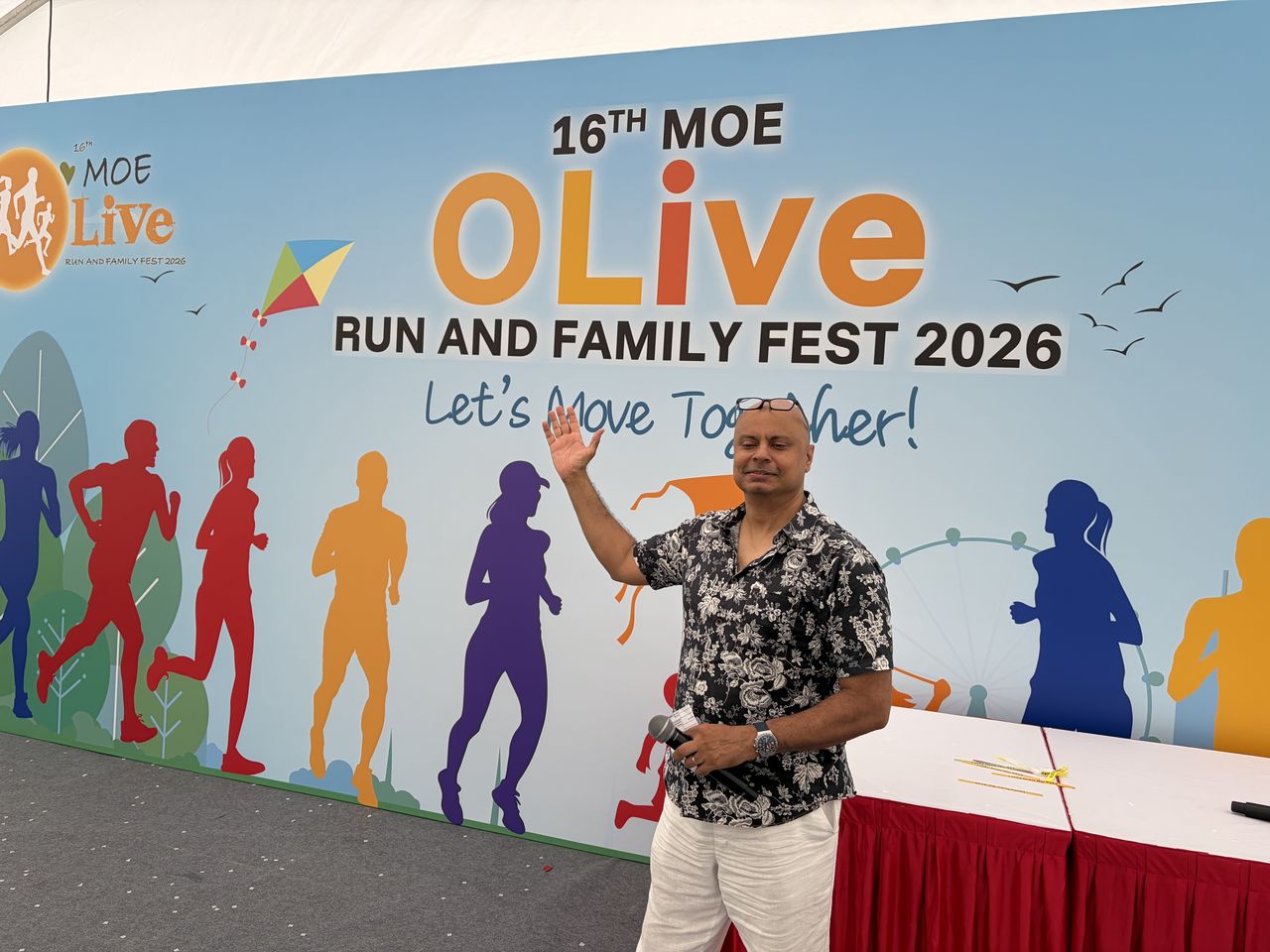 Rico Smith waving at the MOE OLive Run and Family Fest 2026