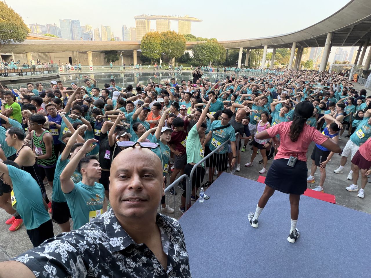 Rico Smith with a crowd of runners warming up at the MOE OLive Run and Family Fest