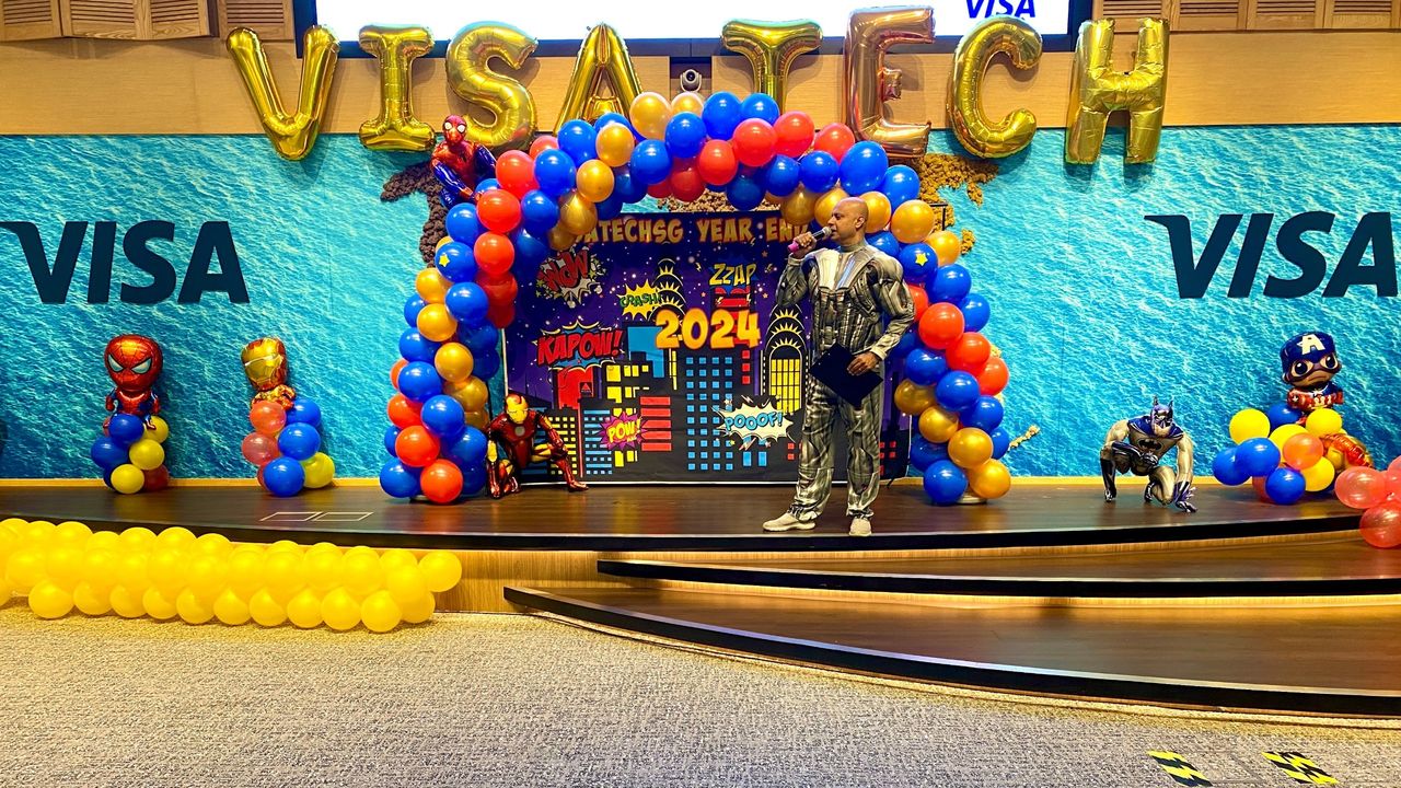 Rico Smith hosting the Visa Tech superhero-themed year-end party