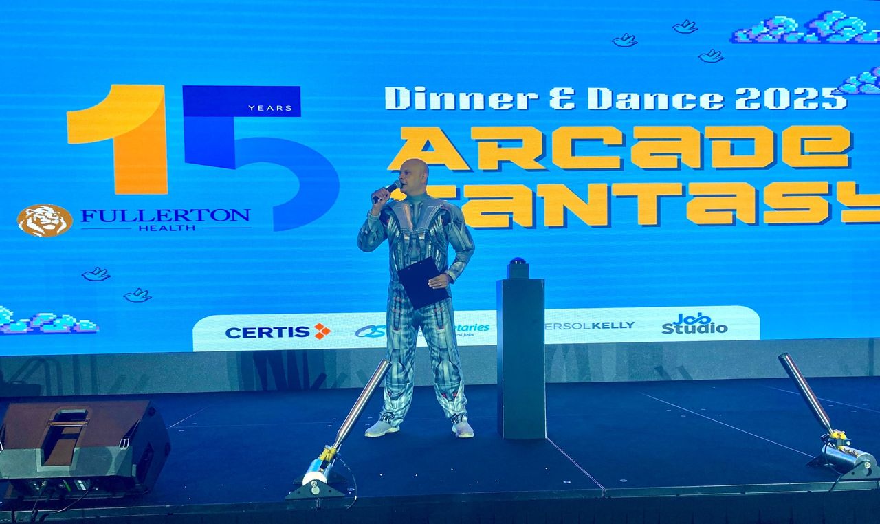 Rico Smith in a robot costume hosting the Fullerton Health Arcade Fantasy dinner and dance