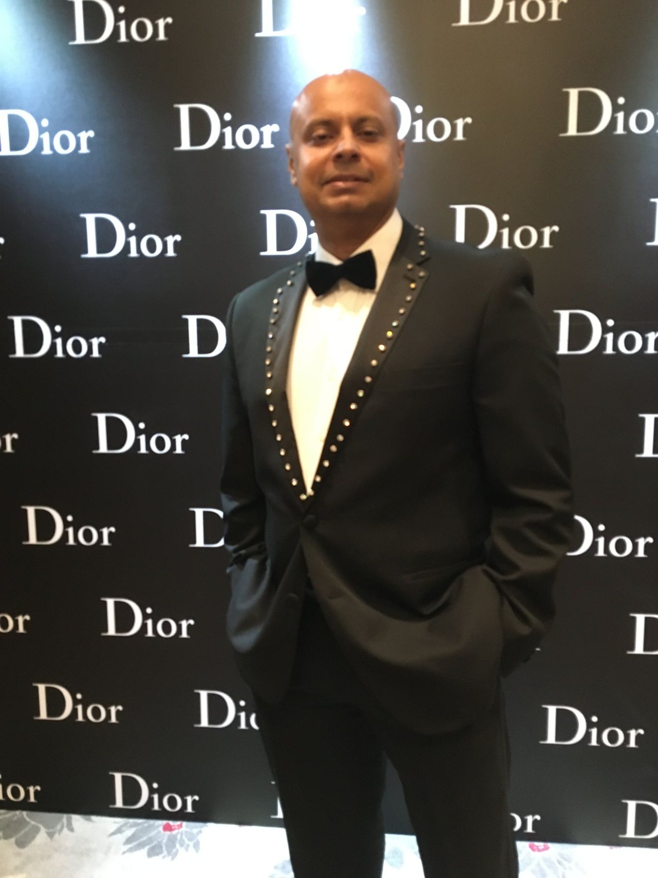 Rico Smith in a tuxedo and bow tie at a Dior event